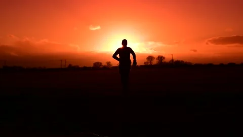 Person running at sunset Stock Footage 169716560