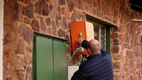 Person safely turns off main power switch and disconnects electrical Stock Footage 281847158