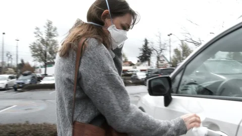Person Sanitizing Surfaces Before Driving Away From Store Stock Footage 127583653