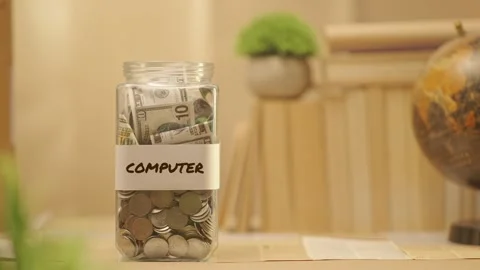 PERSON SAVING MONEY FOR COMPUTER Video stock 274391736