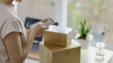 A person scanning item package to delivery service for sending and transfers Stock Footage 334644713