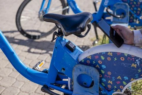 Person scanning qr code on public bicycle for sharing 스톡 사진