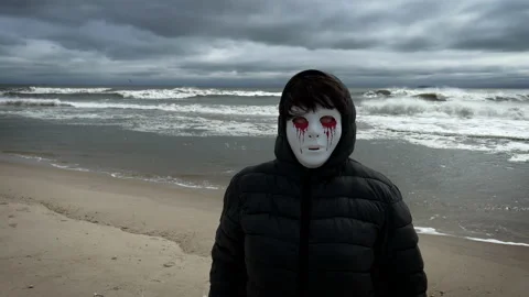 Person with a scary mask on the beach. Stock Footage 218613938