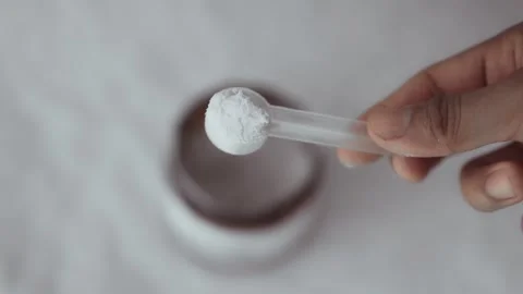 Person scooping micronized monohydrate for training nutrition 库存影片 330189040