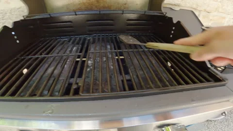 Person scraping a grill Stock Footage 246768573