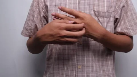 Person scratching his back hand area isolated yellow background Stock Footage 275126417