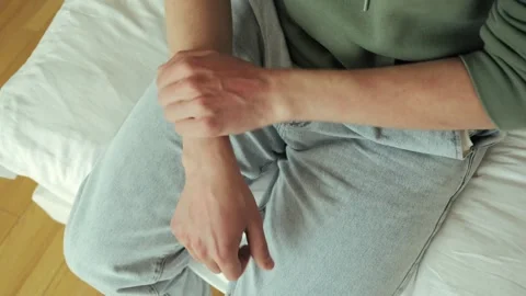 Person scratching their arm, possibly due to nervousness or dermatological Stock-Footage 280141520