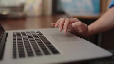 Person scrolling on a laptop touchpad Stock Footage 344316037