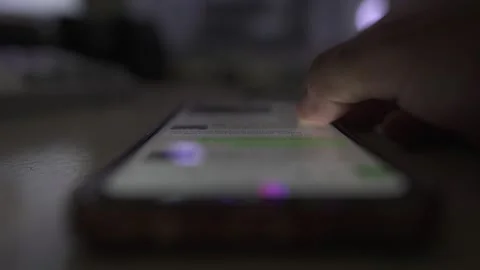 Person scrolling smartphone by hand Stock Footage 290951074