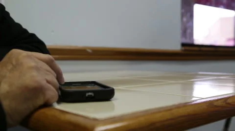 Person scrolling through a cell phone 動画素材 44667012