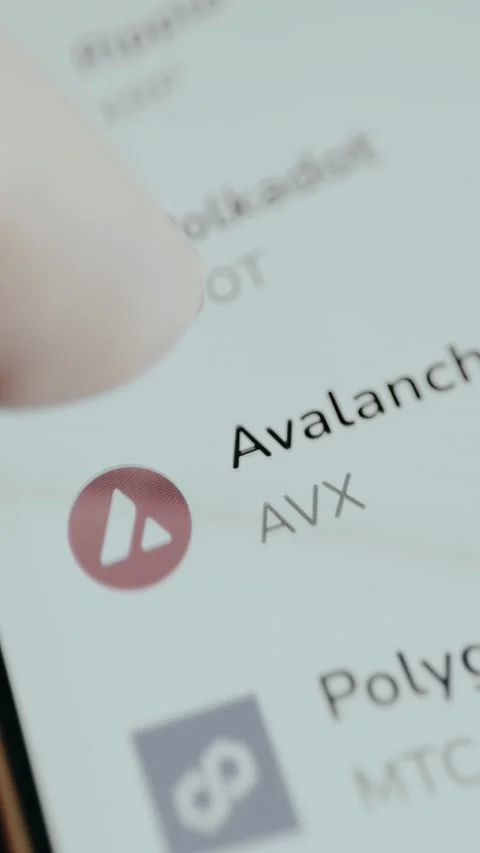 Person scrolls a list of cryptocurrency assets and their perspective ticker Stock Footage 330258183