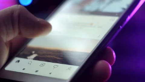 A person scrolls through a feed on a social network in close-up, Stock Footage 126488893