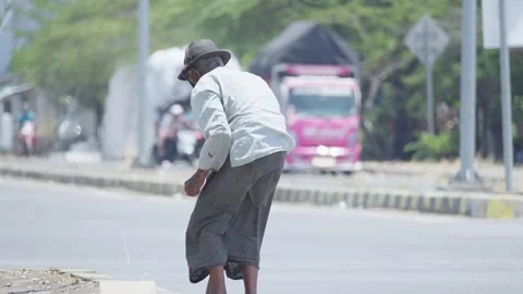 Person Searching for Something Along a Roadside Stock Footage 345618888