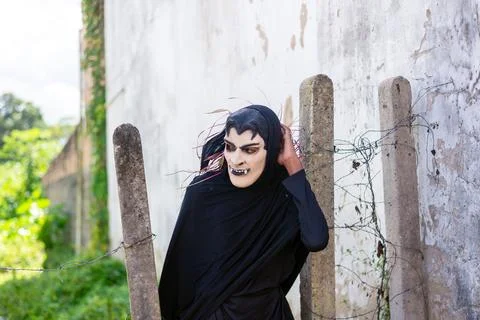 Person is seen dressed in black with a terror mask during a cultural demons.. Stock Photos