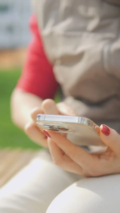 A person is seen using their smartphone while enjoying a beautiful nature Stock Footage 284909422