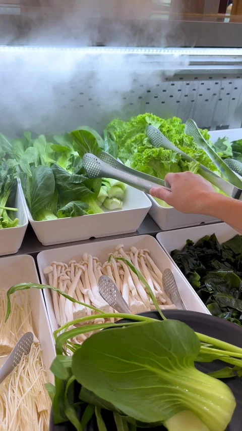 Person Selecting Fresh Green Vegetables at a Buffet Salad Bar Stock-Footage 334282967