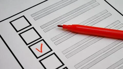 Person selects candidate with red marker on ballot. Italy elections Stock Photos
