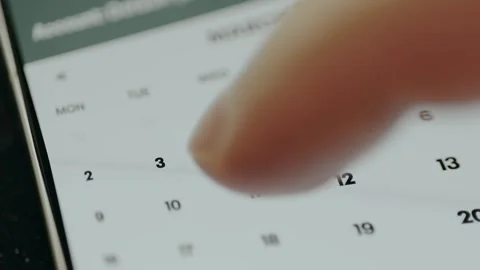 Person selects a date from the digital calendar to introduce financial data for Stock Footage 330257196