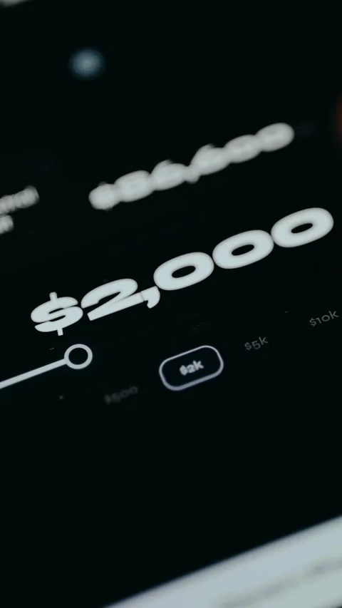 A person selects the required dollar amount from the options in the app Stock Footage 331581944