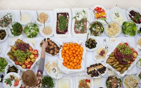Person serves on the big table Stock Photos