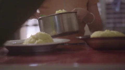 Person serving cooked rice on a plate Stock Footage 341892139
