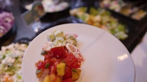 Person Serving Fresh Fruit Salad and Salsa at a Buffet Stock Footage 337394775