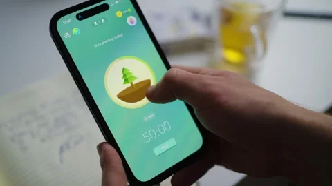 Person sets timer on smartphone productivity app Stock Footage 341670397