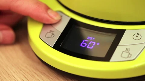 Person setting electric tea kettle temperature to 60 C (140F) 스톡 동영상 63792950