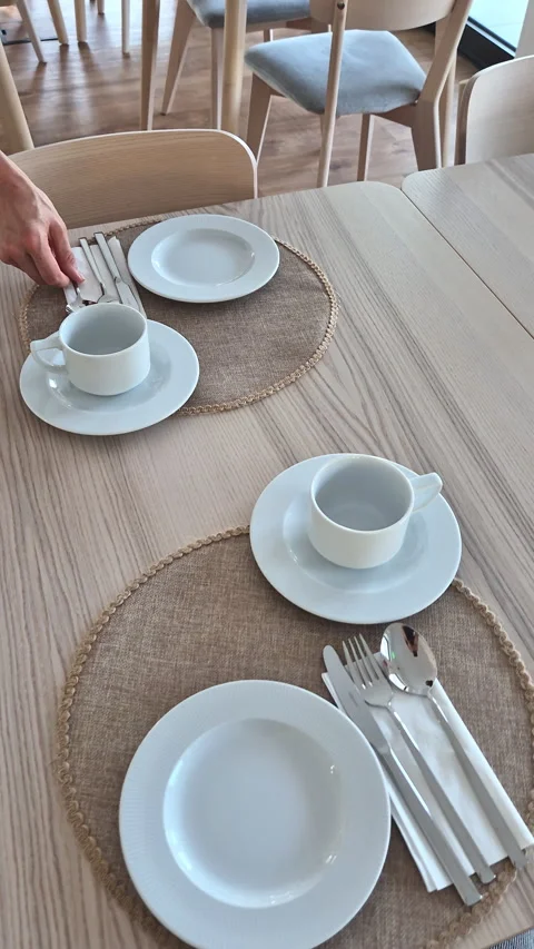 Person Setting an Elegant Breakfast Table with Care Stock Footage 346178481