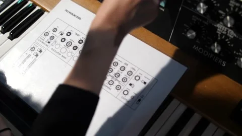 A Person Is Setting Up An Old-Fashioned Analog Synth Oscillator With Stock Footage 219863536