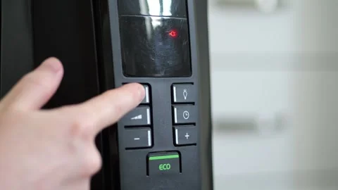 Person setting temperature on modern heater control panel in slow motion Stock Footage 307156039