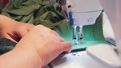 A person sewing clothes using sewing machine Stock Footage 138655621
