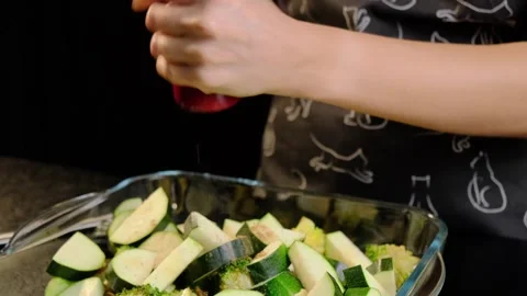 Person Shaking Seasoning Over Vegetables in Cooking Kitchen 스톡 동영상 341434341