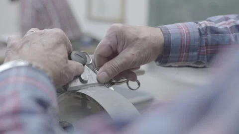 Person Sharpening Scissors Using A Grinding Wheel Stock Footage 264041739