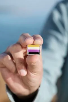 Person showing a non-binary pride flag Stock Photos
