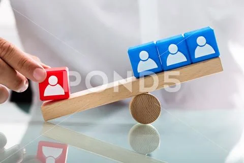 Person showing unbalance between single red and blue blocks Stock Photos