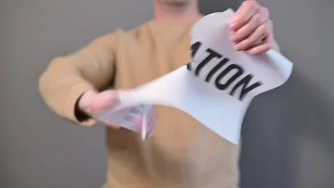 A person is shown in four frames performing actions with a piece of paper Stock Footage 338299770