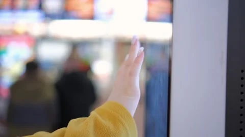 A person is shown interacting with technology on a touchscreen, demonstrating Stock Footage 278676276