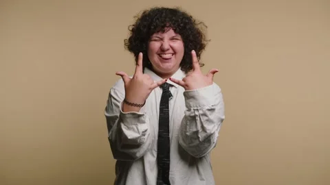 Person shows different fun expressions in a studio setting with a plain bac.. Stock Footage 331990646