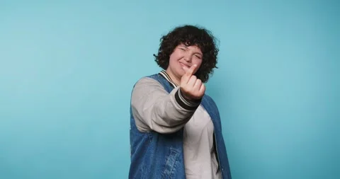 Person shows different hand gestures with a blue background in a photo sess.. Vídeo Stock 328247190