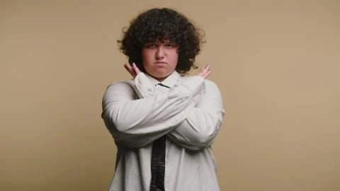 Person shows different hand gestures with crossed arms on a plain backgroun.. Stock Footage 331990641
