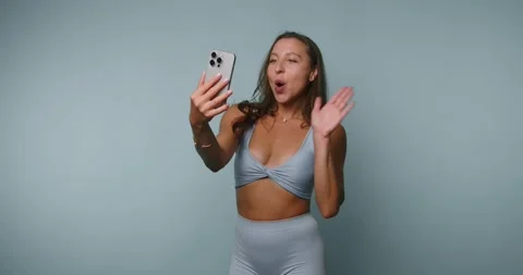 Person shows expressions while taking selfies indoors during the day Vídeo Stock 331990192