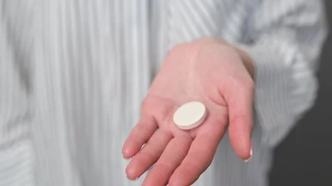 A person shows a flat white tablet in their hand from various angles. Stockbeeldmateriaal 337556740
