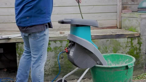 Person shredding the branches with an electric Shredder Stock Footage 168947053