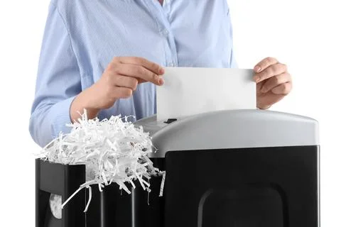 Person shredding confidential documents for data protection and privacy, isol Stock Photos