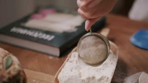 Person sifting flour Stock Footage 130383326