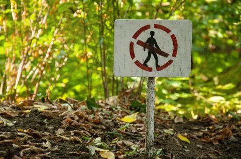 A person sign is prohibited. Pointer prohibiting passage in the forest. Prohi Stock Photos
