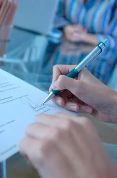 Person signing on document, close-up Stock Photos
