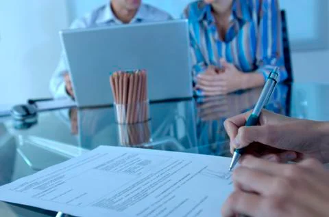 Person signing on document, close-up Stock Photos