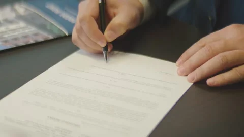 Person signing important document on desk in office footage. Stock Footage 344998316